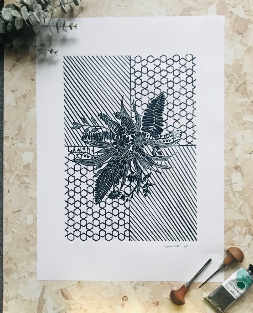 Black and white flower lino print on geometric background