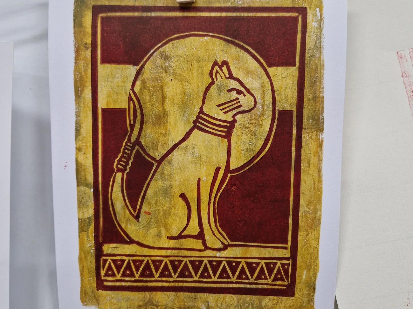 Linoprint of cat on gelli plate background